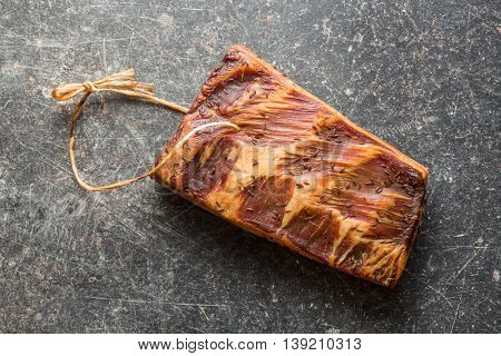 Fresh smooked bacon on old kitchen table.