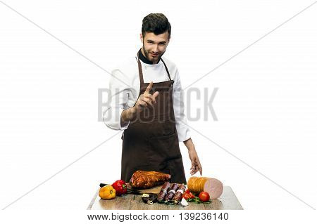 young cheaf with salami on the table isolated on white background