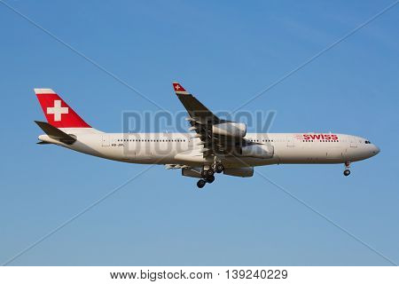 ZURICH - JULY 18: Swiss A-340 landing in Zurich airport after intercontinental flight on July 18, 2015 in Zurich, Switzerland. Zurich airport is one of the biggest european hubs.