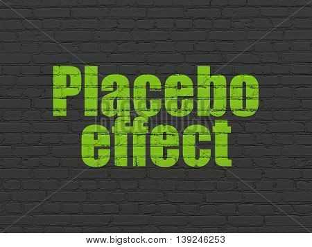 Medicine concept: Painted green text Placebo Effect on Black Brick wall background