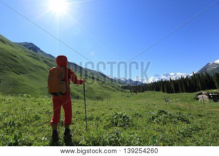 young woman backpacker hiking at beautiful mountains in xinjiangchina