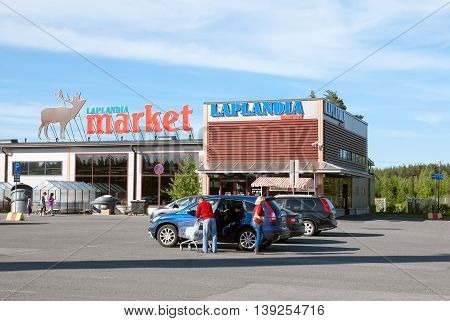 LAPPEENRANTA, FINLAND - JUNE 15, 2016: Laplandia Market near Finnish-Russian border. People put purchases into the car