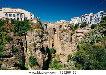The New Bridge or Puente Nuevo Is The 120-metre-deep Chasm That Carries The Guadalevin River And Divides City Of Ronda, Province Of Malaga, Spain. Famous Landmark