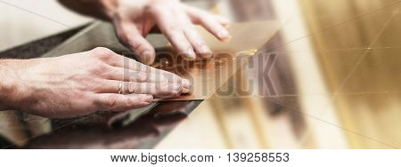 Master works with a thin gold leaf pieces on glass hands in the center of the frame