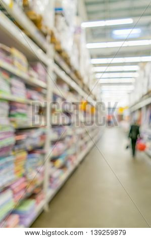 People are shopping in a supermarket. Blur and defocus image as a background and postcard designs.