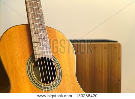 Cajon in background and guitar in foreground