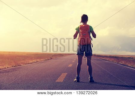 young woman hiker hiking at beautiful mountain trail