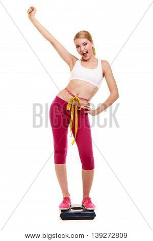 Woman Measuring On Weighing Scale With Raised Arm.