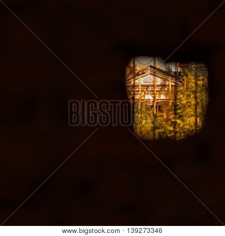 Real view of the old church through the vintage small window in the abandoned medieval house. For background, with empty space for your message, square. Photoart