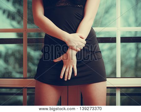 Sexy female body in black dress. Seduction and fashion