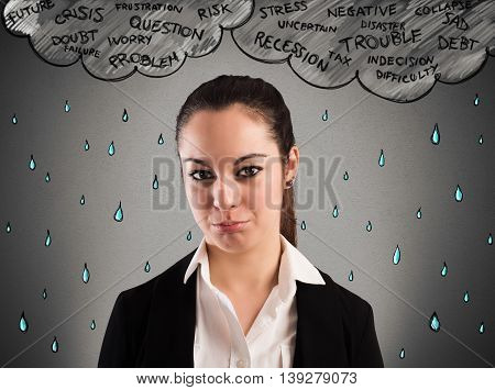 Businesswoman crying with cloud over his head and rain
