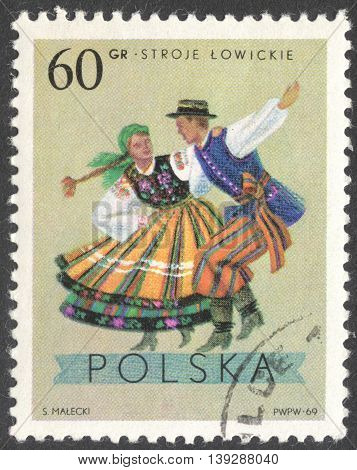 MOSCOW RUSSIA - CIRCA JANUARY 2016: a post stamp printed in POLAND shows traditional Polish dancing the series "Folk Costumes" circa 1969