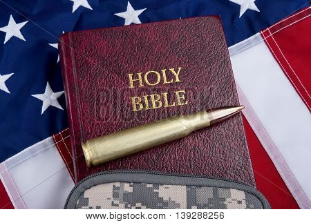 Religion and peace with fifty caliber bullet bible and American flag .