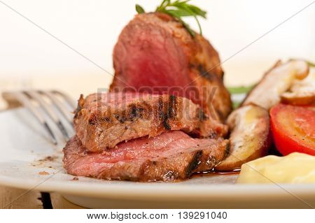 beef filet mignon grilled with vegetables isolated on a white background