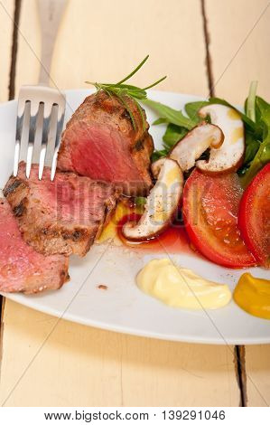 close up image of beef filet mignon grilled with vegetables