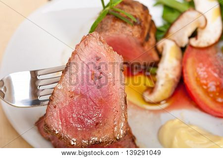 close up image of beef filet mignon grilled with vegetables