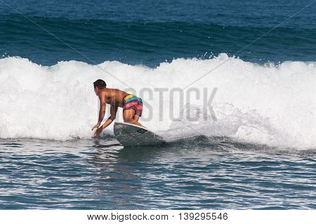 BALI, INDONESIA, 8 April 2016: Surfing in Kuta. Kuta is a beach and resort area in the south of the island of Bali, Indonesia. One of Bali's first tourist developments, it's best known for its Indian Ocean surfing and party-centric atmosphere.