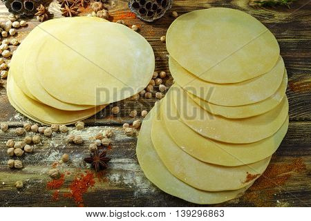 Colorful Indian food - papadum chickpea gram flour and spices on textured wooden table top