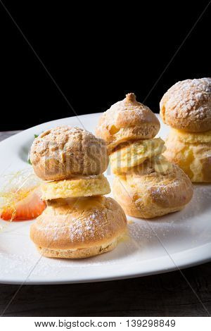 Sweet eclairs dessert served on w hite plate