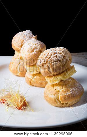 Sweet eclairs dessert served on w hite plate