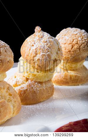 Sweet eclairs dessert served on w hite plate