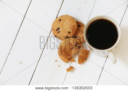 Cookies and coffee on white wooden palette