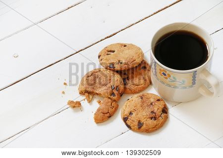 Cookies and coffee on white wooden palette