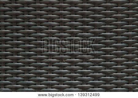 Closeup surface wood pattern at black painted wood weave chair texture background