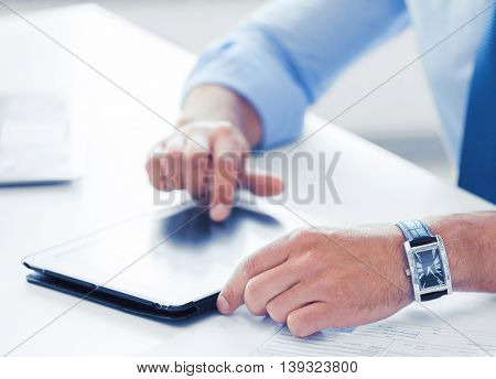 business, office, school and education concept - businessman with tablet pc in office