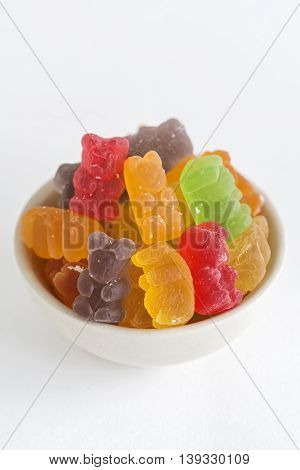 Bowl of Fruity Haribo Gummy Bears on White Background. (Selective Focus)