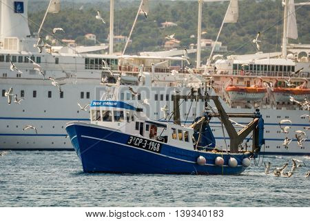Palamos, Catalonia may 2016: Fishing motor boat fishing trawls on Mataro bay.