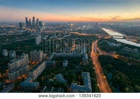 Panorama of residential district, road, river and skyscrapers during sunset in Moscow