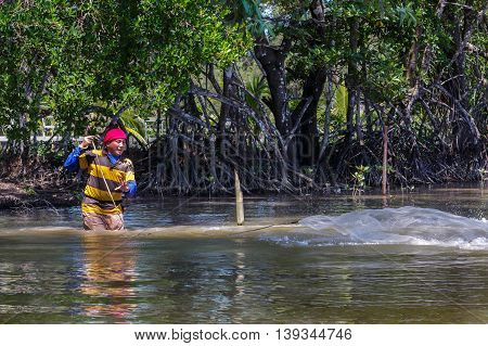 Tuaran, Sabah, Malaysia - June 7, 2016: Unidentified fisherman catch fish by throwing net.
