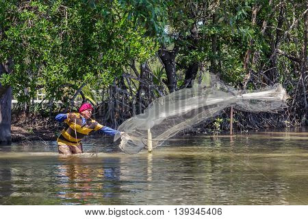 Tuaran, Sabah, Malaysia - June 7, 2016: Unidentified fisherman catch fish by throwing net.
