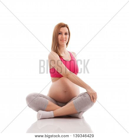 Pregnant woman limbering after exercising isolated, close up