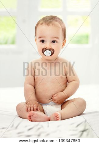 Baby with pacifier in mouth, close up