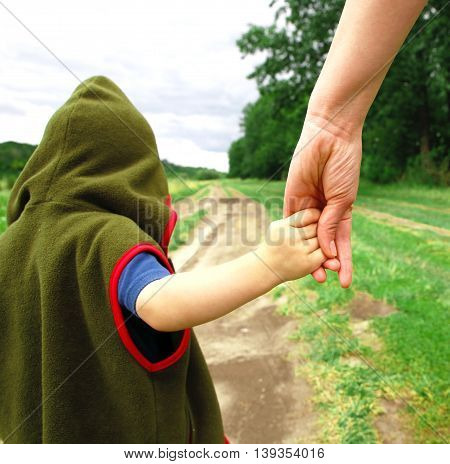 gentle parental hands holding the child's hand photo for micro-stock