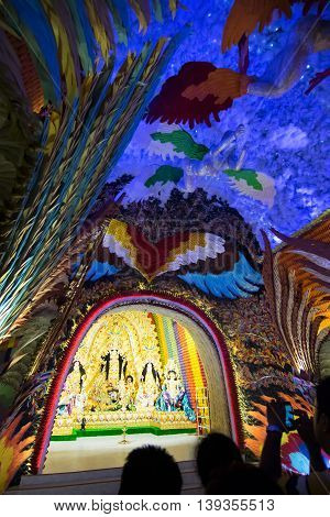 KOLKATA INDIA - OCTOBER 18 2015 : Night image of decorated Durga Puja pandal shot at colored light at Kolkata West Bengal India. Durga Puja is biggest religious festival of Hinduism.