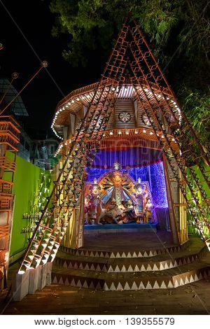 KOLKATA INDIA - OCTOBER 18 2015 : Night image of decorated Durga Puja pandal shot at colored light at Kolkata West Bengal India. Durga Puja is biggest religious festival of Hinduism.