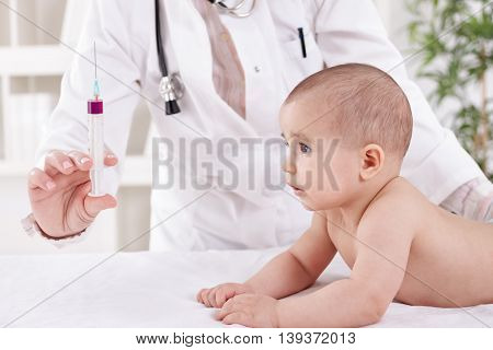 Frightened Baby Child Looking In To The Vaccine