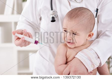 Craying Little Baby Boy Receive Vaccine