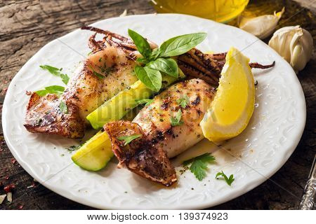 Grilled Squid With Lemon And Zucchini On Wooden Background