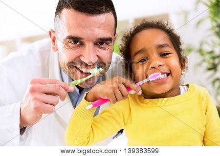 Pediatrician Learn Cute African Girl Brushing Tooth