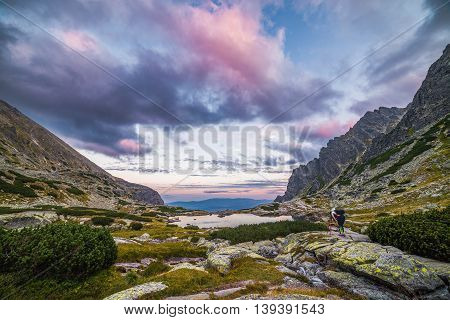 Tourist Takes Picture of Mountain Landscape with a Tarn in the Evening. Mlynicka Valley High Tatra Slovakia.