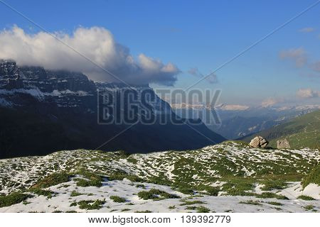 Scene after snowfall in Summer. View from a place near Klausenpass towards Glarus. Swiss Alps.
