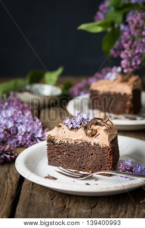 A slice of chocolate mud cake with chocolate frosting