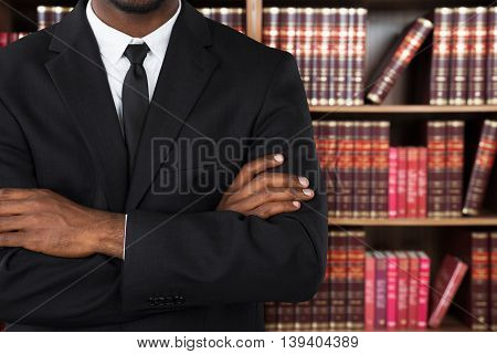 Close-up Of A Male Lawyer With Arms Crossed In Office