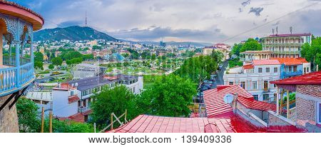 TBILISI GEORGIA - MAY 28 2016: Panoramic view of the city with Sololaki Hill Rike Park Peace bridge and the balcony of Sachino Palace on May 28 in Tbilisi.