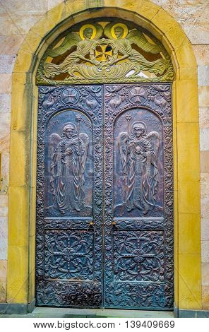 TBILISI GEORGIA - MAY 28 2016: The entrance to Anchiskhati Basilica of St Mary decorated with icons and traceries stamped on metal on May 28 in Tbilisi.