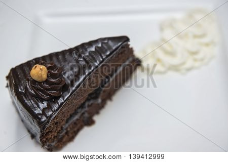 Slice of chocolate cake served with whipped cream